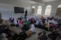 Yemeni children studying in a destroyed school