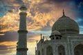 Taj Mahal dome and tower minar against sunset