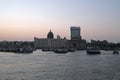 Taj Mahal hotel, Gateway of India and tourist boats in water of Arabian Sea on sunset in Mumbai