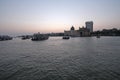 Taj Mahal hotel, Gateway of India and tourist boats in water of Arabian Sea on sunset in Mumbai Royalty Free Stock Photo