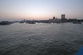 Taj Mahal hotel, Gateway of India and tourist boats in water of Arabian Sea on sunset in Mumbai