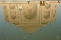 The Taj Mahal main building reflected in a water tank.