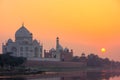 Taj Mahal reflected in Yamuna river at sunset in Agra, India