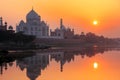 Taj Mahal reflected in Yamuna river at sunset in Agra, India