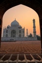 Taj Mahal at sunrise framed with the arch of the mosque, Agra, Uttar Pradesh, India Royalty Free Stock Photo