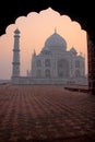 Taj Mahal at sunrise framed with the arch of the mosque, Agra, Uttar Pradesh, India Royalty Free Stock Photo