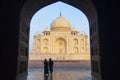 Taj Mahal view in black arch silhouette from the mosque in Agra, Uttar Pradesh, India