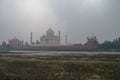 Taj Mahal and Yamuna river view in morning fog from Mehtab Bagh or The Moonlight Garden, Agra Royalty Free Stock Photo