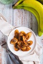 Tajadas fried banana on a plate on the table top and vertical view Royalty Free Stock Photo