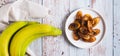 Tajadas fried banana on a plate on the table top view web banner Royalty Free Stock Photo