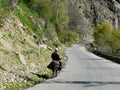 Tajik rides on a donkey on a mountain road