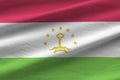 Tajikistan flag with big folds waving close up under the studio light indoors. The official symbols and colors in banner