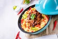 Tajin with couscous, vegetables and meat on white background