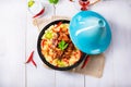 A Tajin with couscous, vegetables and meat on white background