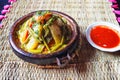 Tajine or tagine - traditional Berber dish served in earthenware bowl at typical Moroccan street restaurant, closeup detail