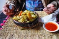 Tajine or tagine - traditional Berber dish served in earthenware bowl at typical Moroccan street restaurant, closeup