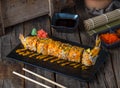 TAKATO suhi roll served in a cutting board isolated on wooden background side view of sushi roll Royalty Free Stock Photo