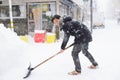 Takayama, Japan - January 16,2017 : Japanese man with snow shovel removing snow on the road in winter time at Takayama old town Royalty Free Stock Photo