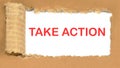 TAKE ACTION the inscription appearing behind the torn cardboard paper Royalty Free Stock Photo