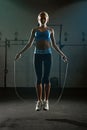 Take action, just jump. a young woman jumping rope in a gym. Royalty Free Stock Photo