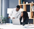 Take action and make things happen. Shot of a young businessman and businesswoman using a digital tablet and laptop in a Royalty Free Stock Photo