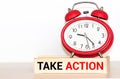 Take action now words written on wooden table with clock,dice,calculator pen and compass