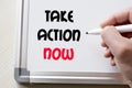 Take action now written on whiteboard Royalty Free Stock Photo