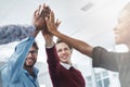 The take action team. a team of young go getters giving each other a high five in a modern office. Royalty Free Stock Photo