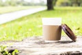 Take-away coffee cup or disposable cup with a black plastic cap