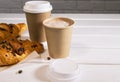 Take Away Coffee in Paper Eco Cup and Fresh Croissant With Chocolate drops on wooden background, Copy Space Royalty Free Stock Photo