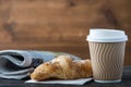 Take away coffee and fresh croissant and newspaper Royalty Free Stock Photo