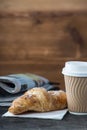 Take away coffee and fresh croissant and newspaper Royalty Free Stock Photo