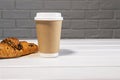 Take Away Coffee in Paper Eco Cup and Fresh Croissant With Chocolate drops on wooden background, Copy Space Royalty Free Stock Photo