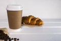 Take Away Coffee in Paper Eco Cup and Fresh Croissant With Chocolate drops on wooden background, Copy Space Royalty Free Stock Photo