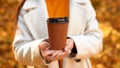 take away coffee or tea in woman hands - hot drink in fall weather. brown paper cup with natural coffee for break Royalty Free Stock Photo