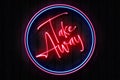 Take Away Neon Sign on a Dark Wooden Wall