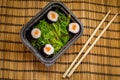 Take away sushi dish with algae and chopsticks