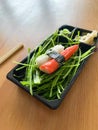 Take Away Sushi Kani Nigiri Surimi Crab with Chopsticks in Black Plastic Plate