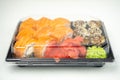 Take away sushi in plastic containers, philadelphia rolls and unagi maki, soy sauce, pink ginger, wasabi, sushi delivery concept Royalty Free Stock Photo