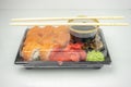 Take away sushi in plastic containers, philadelphia rolls and unagi maki, soy sauce, pink ginger, wasabi, sushi delivery concept Royalty Free Stock Photo