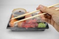 Take away sushi in plastic containers, philadelphia rolls and unagi maki, soy sauce, pink ginger, wasabi, sushi delivery concept Royalty Free Stock Photo