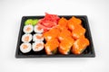 Take away sushi rolls in plastic container, california, salmon maki roll, pink ginger, wasabi. sushi delivery concept