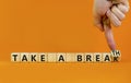 Take a break and breath symbol. Doctor turns cubes, changes words Take a break to Take a breath. Beautiful orange background, copy Royalty Free Stock Photo