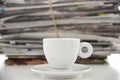 Cup of coffee and pile of newspapers