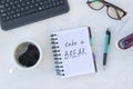 Take a break. Concept time off. Words Take a break in notebook on the working table with cup of coffee Royalty Free Stock Photo