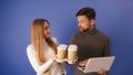 Take a break concept. Woman bringing take away coffee cups to a coworker with laptop Royalty Free Stock Photo