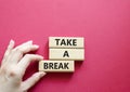 Take a break symbol. Concept words Take a break on wooden blocks. Beautiful red background. Businessman hand. Business and Tak Royalty Free Stock Photo