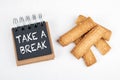 TAKE A BREAK. Work and study load, stress and rest concept. Black notebook and cookies Royalty Free Stock Photo