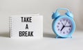 Take a break written in a notepad on a white background. business concept, flat top view