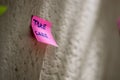 Take care message written on a paper post-it sticked against a wall Royalty Free Stock Photo